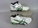 two pairs of white and green tennis shoes sitting on top of a box
