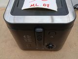 a toaster that has a piece of paper on top of it