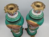 pair of green and gold vases with floral designs on them