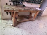 a workbench that has a bunch of tools on it