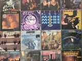 many different album covers on the wall of a room