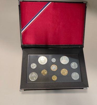 an image of a box of coins on a table with a red background