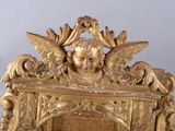 a gold clock with a statue on top of it