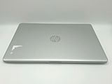 the back of a laptop computer sitting on top of a white table