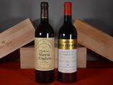 two bottles of wine sitting next to each other on a table
