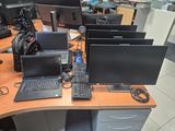 a desk with a bunch of computers on top of it