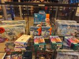 a glass display case filled with toys for sale