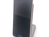 a cell phone that is sitting on top of a stand