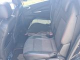 the back seats of a car with a bottle of water in the back