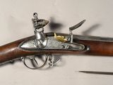 a close up of a gun on a white surface