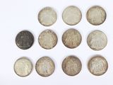 six different types of coins are arranged in a circle on a white surface