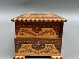an ornate wooden box with a heart on the lid
