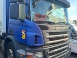 a large blue truck that is parked in a lot