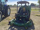 two tractors that are parked next to each other in the field
