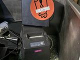a box with a sticker on it sitting next to a computer