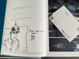 an open book with a drawing of a man in a cowboy hat
