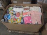 a cardboard box full of baby clothes and other items