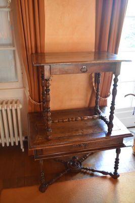 a wooden table with a shelf on it in a room
