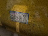 a close up of a sign on the side of a yellow truck