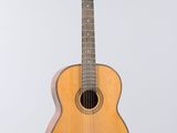an image of a guitar hanging from a string on a wall