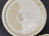 a bowl and a plate that are sitting on a table