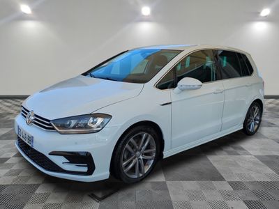 une Volkswagen e-Golf blanche garée dans une pièce au sol à carreaux