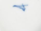 a white plate with a blue bird on it