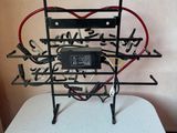 a metal sculpture of a heart with arrows and arrows on it