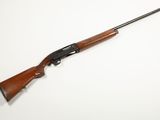 a rifle on a white surface with a white background