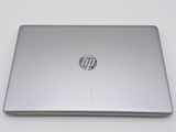 the back of a laptop computer sitting on top of a white table
