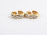 a pair of gold and diamond earrings on a white background