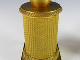 an image of a statue of a woman with a hat on top of a gold vase