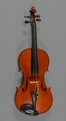 an old violin with a bow hanging on the wall