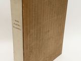 an old book with a brown cover sitting on top of a white table