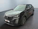 Le SUV noir est garé dans une grande pièce au sol noir.