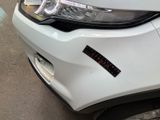 a close up of a car ' s headlight with a sticker on it