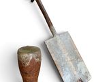 an old shovel and a wooden block on a white background