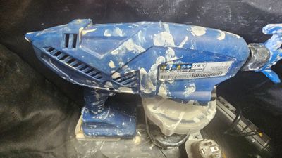 a blue and white model of a space ship on a black surface