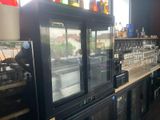 many bottles of alcohol sitting on the shelves in the bar