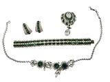 a close up of a necklace, bracelet, and earrings on a white background