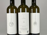 three bottles of wine sitting next to each other on a table