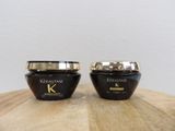 two jars of kerastase hair products sitting on a table