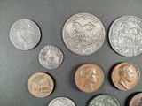 six different types of coins on a table with a black background