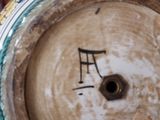 a clock that has a musical note on the side of it