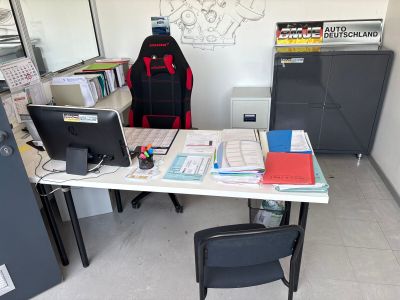 a desk with a chair and a computer on it