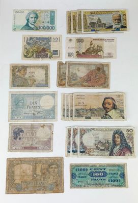 several different types of paper money are displayed on a white surface
