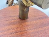 a wooden base with a metal object on it