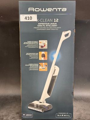 the box of a vacuum cleaner is sitting on the floor