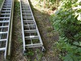 two ladders that are sitting in the grass