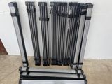a group of metal rods sitting next to each other on top of a floor